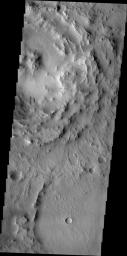 Dark slope streaks are visible on the rim of this unnamed crater located on the floor of Cassini Crater in this image from NASA's 2001 Mars Odyssey spacecraft.