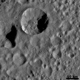 This image from NASA's Dawn spacecraft is dominated by a wide, young, fresh crater on asteroid Vesta. Surrounding this crater is its ejecta blanket, a covering of small particles that were thrown out during the impact that formed the crater.