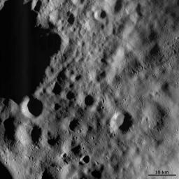 This image from NASA's Dawn spacecraft shows a part of the surface of asteroid Vesta, which is mantled (covered) by an ejecta blanket, evident as smoothly textured surface visible across the image.