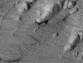 Rhythmic patterns of sedimentary layering in Danielson Crater on Mars result from periodic changes in climate related to changes in tilt of the planet in this image was taken by NASA's Mars Reconnaissance Orbiter.