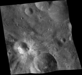 This mosaic of three images was taken by NASA's Dawn framing camera during the high-altitude mapping orbit over the giant asteroid Vesta. The eastern rim is higher than the western rim, and the overall topography is downhill from east to west.