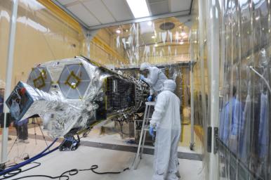 Inside an environmental enclosure at Vandenberg Air Force Base's processing facility in California, technicians complete the final steps in mating NASA's Nuclear Spectroscopic Telescope Array (NuSTAR) and its Orbital Sciences Pegasus XL rocket.