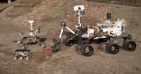 This grouping of two test rovers and a flight spare provides a graphic comparison of three generations of Mars rovers developed at NASA's Jet Propulsion Laboratory, Pasadena, Calif. The setting is JPL's Mars Yard testing area.