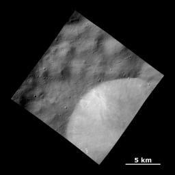This image from NASA's Dawn spacecraft shows a relatively fresh crater with bright deposits exposed in the crater wall that streak downslope on the giant asteroid Vesta.