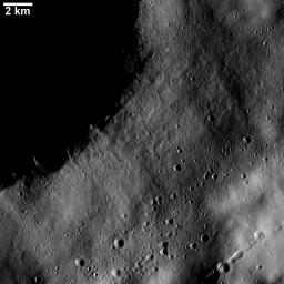This image from NASA's Dawn spacecraft shows numerous linear chains and clusters of small craters on asteroid Vesta. These chains and clusters of craters were created by material that was ejected during the formation of a large crater.
