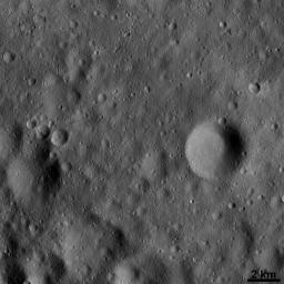 This image from NASA's Dawn spacecraft shows a large number of craters, formed by collisions into the surface of asteroid Vesta. The relatively large circular depressions in this image are older, heavily degraded impact craters.