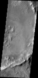 Dark slope streaks mark the rim of this unnamed crater withing Tikhonravov Crater in Terra Sabaea as seen by NASA's 2001 Mars Odyssey spacecraft.