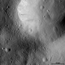 This image from NASA's Dawn spacecraft of asteroid Vesta shows hows a large impact crater whose rim is rather smoothed and degraded. There are many smaller, younger craters surrounding and inside of this crater and these have sharper, fresher rims.