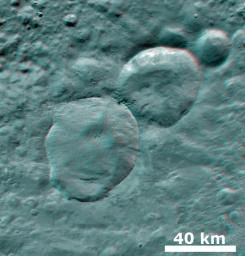 This anaglyph from NASA's Dawn spacecraft shows three fresh craters on asteroid Vesta, which have been nicknamed the 'Snowman' craters. You need 3D glasses to view this image.