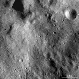 This image of asteroid Vesta from NASA's Dawn spacecraft shows a relatively smooth area of Vesta's surface. This region is smooth because it is mostly covered by fine-grained debris, known as regolith.