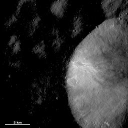 This image of asteroid Vesta from NASA's Dawn spacecraft shows part of a large crater with a relatively fresh rim located in Vesta's Numisia quadrangle, near the equator.