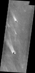These windstreaks, located north of Olympus Mons, indicate winds from the south-southeast. This image is from NASA's 2001 Mars Odyssey spacecraft.