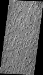 The unusual texture in this image from NASA's 2001 Mars Odyssey spacecraft is located on the plains of Elysium Planitia. The surface appears to be layered. The top layer has parallel, linear hills and channels.