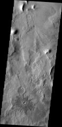 This image from NASA's 2001 Mars Odyssey spacecraft shows a small crater near Phlegra Montes.