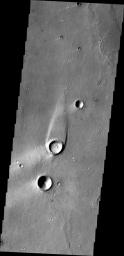 The streamlined island in this image from NASA's 2001 Mars Odyssey spacecraft formed within the channel of Maja Valles. The flow of water was deflected by the crater leaving material in the lee of the crater.