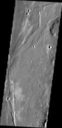 The small channel in this image captured by is located in volcanic flows in the northern part of Tractus Fossae on Mars as seen by NASA's Mars Odyssey spacecraft.