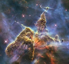 NASA's Hubble Space Telescope captures the chaotic activity atop a three-light-year-tall pillar of gas and dust that is being eaten away by the brilliant light from nearby bright stars in a tempestuous stellar nursery called the Carina Nebula.