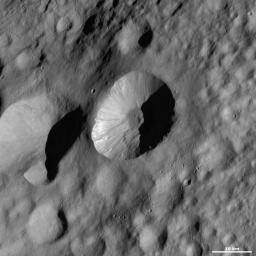 This image from NASA's Dawn spacecraft are located in asteroid Vesta's Floronia quadrangle, in Vesta's northern hemisphere. There are also many hummocky slumps of material around the crater's walls and base.
