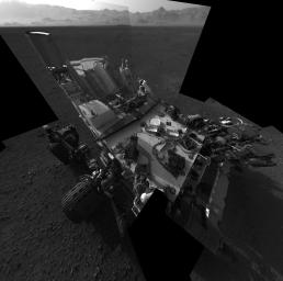 This full-resolution self-portrait shows the deck of NASA's Curiosity rover. The back of the rover can be at top left, two of the right side wheels at left, and the undulating rim of Gale Crater forms the lighter color strip in the background.