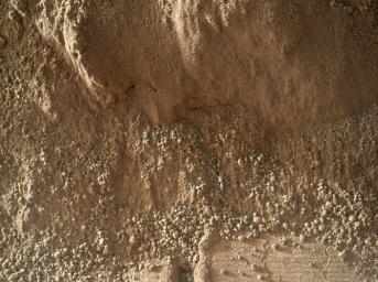 This image shows the wall of a scuffmark NASA's Curiosity made in a windblown ripple of Martian sand with its wheel. The upper half of the image shows a small portion of the side wall of the scuff and a little bit of the floor of the scuff.