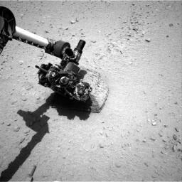 This image shows the robotic arm of NASA's Mars rover Curiosity with the first rock touched by an instrument on the arm. The rover placed the APXS instrument onto the rock to assess what chemical elements were present in the rock.