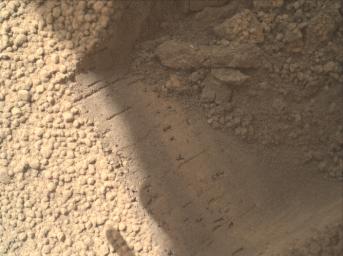This image contributed to an interpretation by NASA's Mars rover Curiosity science team that some of the bright particles on the ground near the rover are native Martian material.