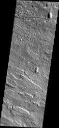 Image captured by NASA's 2001 Mars Odyssey spacecraft shows the eastern flank of Arsia Mons midway between the summit of the volcano and the surrounding plains.