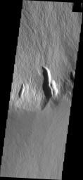 This image captured by NASA's 2001 Mars Odyssey spacecraft shows the steep escarpment between Olympus Mons and the surrounding volcanic plains.
