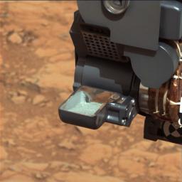 NASA's Curiosity rover shows the first sample of powdered rock extracted by the rover's drill. The image was taken after the sample was transferred from the drill to the rover's scoop.