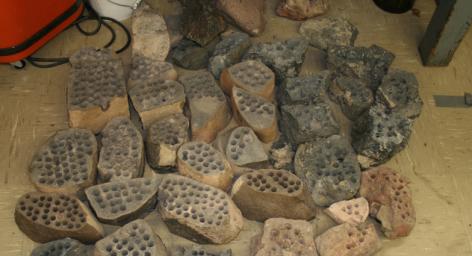 The development of the Mars rover Curiosity's capabilities for drilling into a rock on Mars required years of development work. Seen here are some of the rocks used in bit development testing and lifespan testing at JPL in 2007.