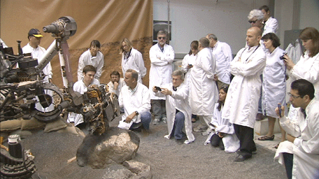 This frame from a video clip shows moments during a demonstration of drilling into a rock at NASA's JPL, Pasadena, Calif., with a test double of the Mars rover Curiosity. The drill combines hammering and rotation motions of the bit.