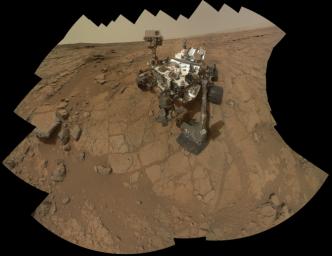 The rover is positioned at a patch of flat outcrop called 'John Klein,' which was selected as the site for the first rock-drilling activities by NASA's Curiosity. This self-portrait was acquired to document the drilling site.