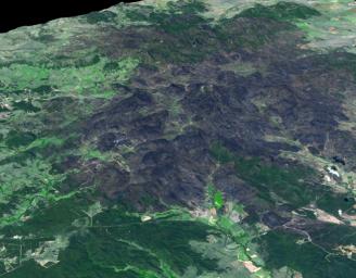This 3-D view was created from data acquired Feb. 4, 2013 by NASA's Terra spacecraft showing a massive wildfire which damaged Australia's largest optical astronomy facility, the Siding Spring Observatory.