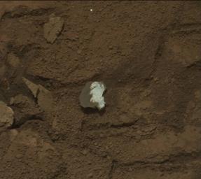 This raw image of 'Tintina,' a broken rock fragment in a rover wheel track, was taken by Curiosity's Mast Camera (Mastcam).