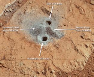 This image shows the first holes into rock drilled by NASA's Mars rover Curiosity, with drill tailings around the holes plus piles of powdered rock collected from the deeper hole and later discarded.