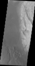 This image from NASA's Mars Odyssey spacecraft shows the southwestern floor of Gale Crater. A fairly large channel that dissects the crater rim is visible entering from the bottom of the frame and continuing northward.