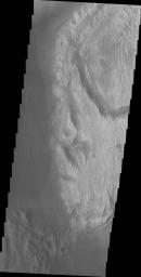 This image from NASA's Mars Odyssey spacecraft shows dark material at the bottom of the image, likely deposited by the large channel. It shows how close that material is to Mt. Sharp and how different the two deposits appear in a visible wavelength image.