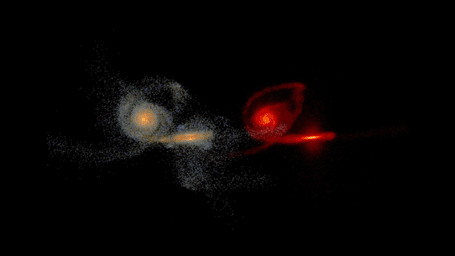 This frame from a simulation shows the merging of two massive galaxies. The merging galaxies are split into two views: a visible-light view on the left, and infrared view on the right.