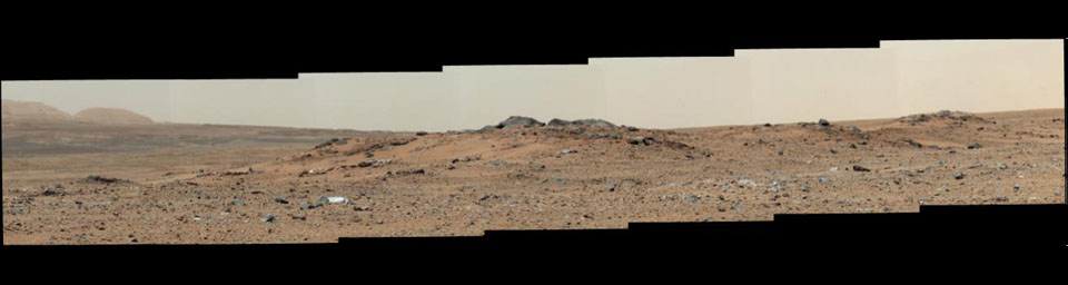 A rise topped by two gray rocks near the center of the scene is informally named 'Twin Cairns Island' as seen by NASA's Mars rover Curiosity. The center of the scene is toward the southwest.