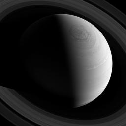 Just as Saturn's famous hexagonal shaped jet stream encircles the planet's north pole, the rings encircle the planet, as seen from NASA's Cassini spacecraft's position high above.