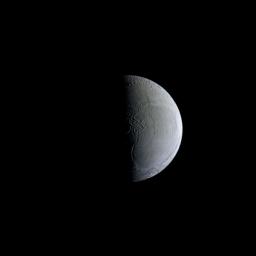 NASA's Cassini spacecraft captures a still and partially sunlit Enceladus. The Saturnian moon is covered in ice that reflects sunlight similar to freshly fallen snow, making Enceladus one of the most reflective objects in the solar system.