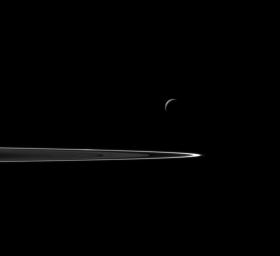 Following a successful close flyby of Enceladus, NASA's Cassini spacecraft captured this artful composition of the icy moon with Saturn's rings beyond.