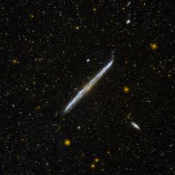 This image from NASA's Galaxy Evolution Explorer shows NGC 4565, one of the nearest and brightest galaxies not included in the famous list by 18th-century comet hunter Charles Messier.