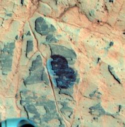 Researchers used NASA's Mars Exploration Rover Opportunity to find a water-related mineral on the ground that had been detected from orbit, and found it in the dark veneer of rocks on the rim of Endeavour Crater.