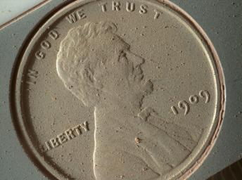 This image of a U.S. penny on a calibration target was taken by the Mars Hand Lens Imager (MAHLI) aboard NASA's Curiosity rover in Gale Crater on Mars. At 14 micrometers per pixel, this is the highest-resolution image that MAHLI can acquire.