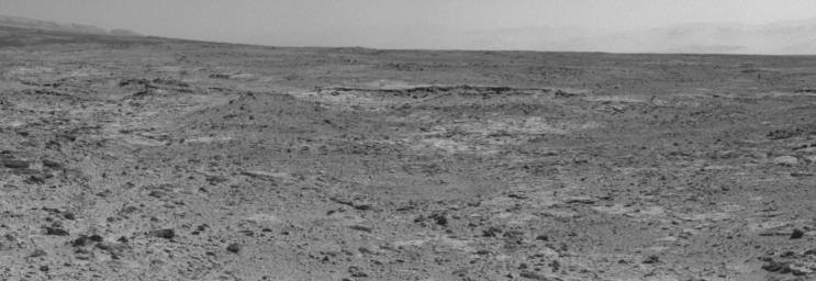 The low ridge that appears as a dark band below the horizon in the center of this scene is a Martian outcrop called 'Cooperstown,' a possible site for contact inspection with tools on the robotic arm of NASA's Mars rover Curiosity.