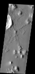 The small hill in this image aptured by NASA's 2001 Mars Odyssey spacecraft of Amazonis Planitia has several dark slope streaks, believed to form when down slope movement of rocks or other debris clear off some of the dust cover.