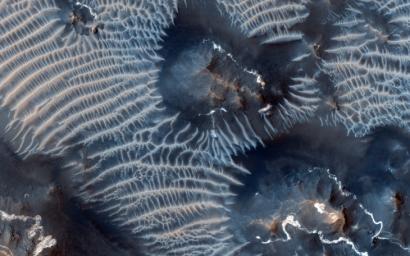 This colorful scene is situated in the Noctis Labyrinthus, perched high on the Tharsis rise in the upper reaches of the Valles Marineris canyon system as seen by NASA's Mars Reconnaissance Orbiter.