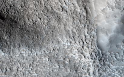 This image from NASA's Mars Reconnaissance Orbiter shows an impact crater with a diameter of approximately 2 kilometers located in the Coloe Fossae region of Mars.