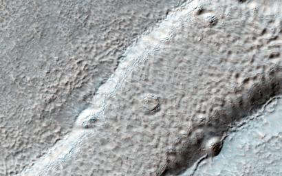 Imaged by MRO's NASA's Mars Reconnaissance Orbiter Context Camera, this observation shows one of two odd, rounded mesas with a knobby, pitted texture.